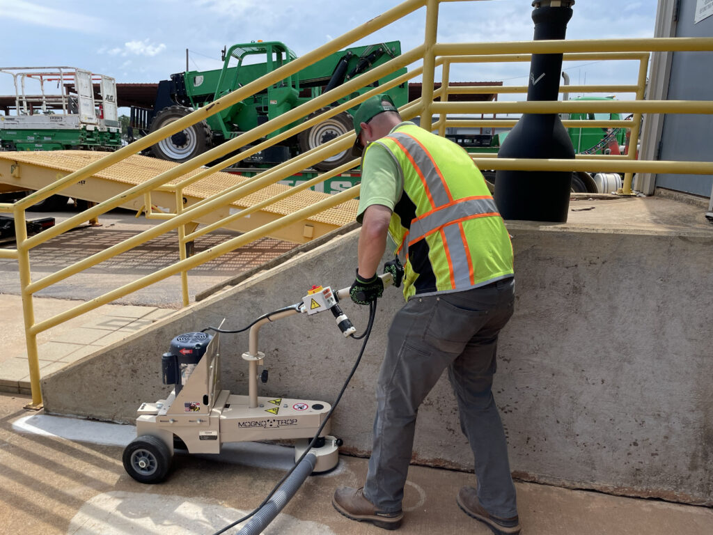Worker using Magna-Trap Turbo Edge Grinder